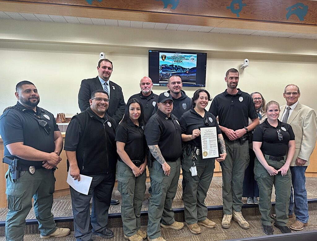Sandoval County Detention Center Correctional Officers and Command Staff with Warden Gilbert Armendariz (second from left, first row), and Deputy Warden Chris Urbanic (center, second row) with Commissioners Jordan Juarez, Katherine Bruch, and Michael Meek.