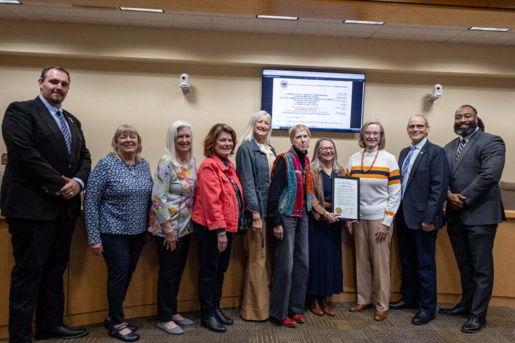 Group photo of Sandoval County Commissioners and members from Jardineros de Placitas.