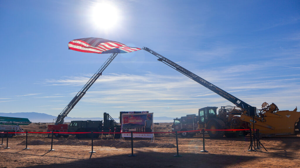 Ladder trucks from Sandoval County Fire Rescue and Bernalillo County Fire and Rescue prepare to fly the flag.