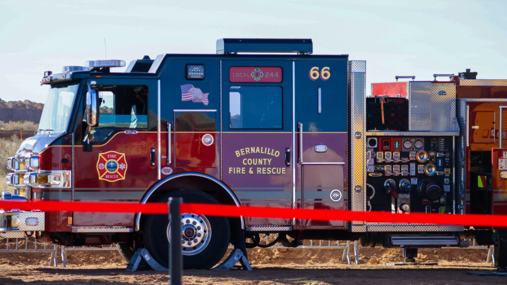 Ladder trucks from Sandoval County Fire Rescue and Bernalillo County Fire and Rescue prepare to fly the flag.