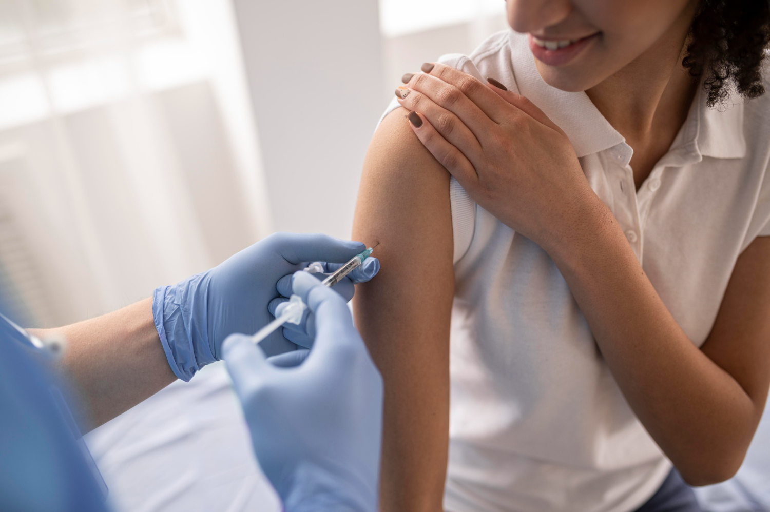 Women getting in shot in her right shoulder