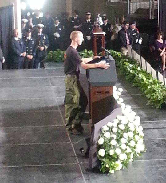 Firefighter speaking at a memorial
